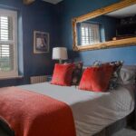 An image of a bedroom with a double bed configuration